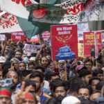 Two dead and dozens injured as thousands protest against prime minister in Bangladesh