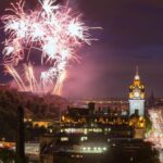 Edinburgh Cityscape with fireworks over The Castle and Balmoral Clock Tower