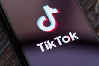 An image of the TikTok logo on a phone screen